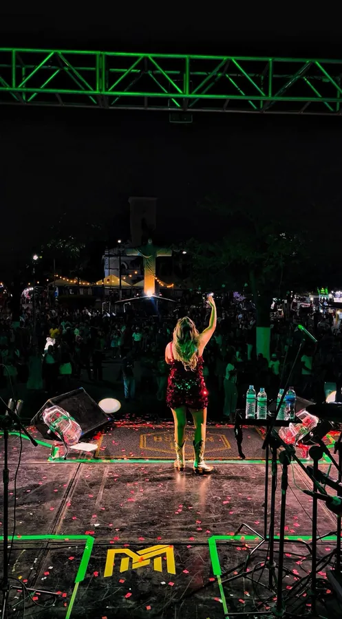 Mayara vista de costas diante do público